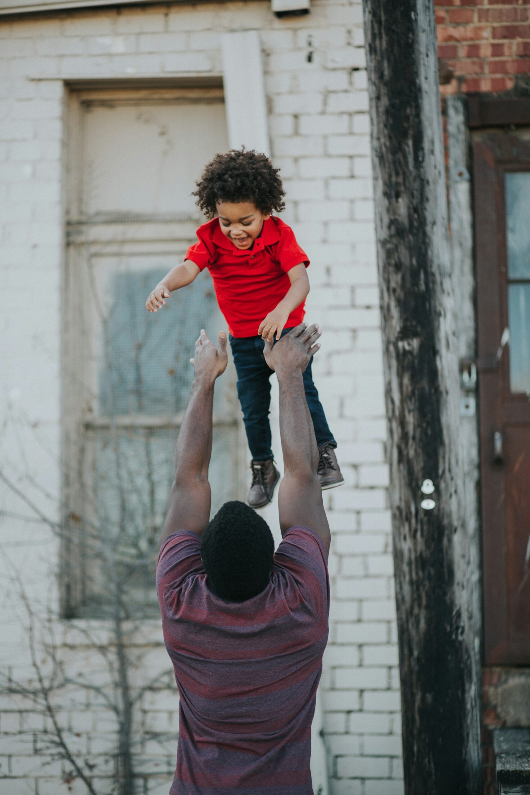 Dad throwing his kid into the air - American Dream Story