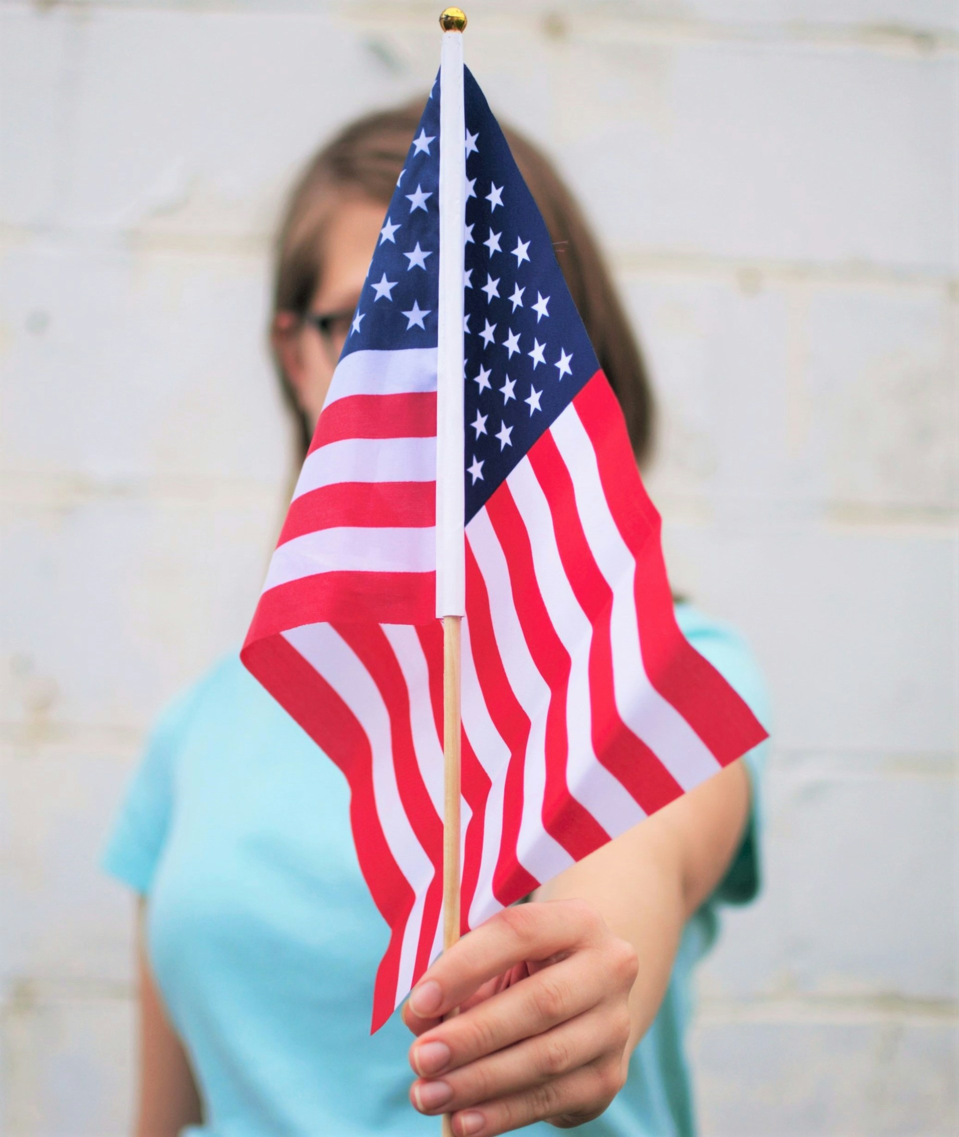 Woman holding an American flag - American Dream Story