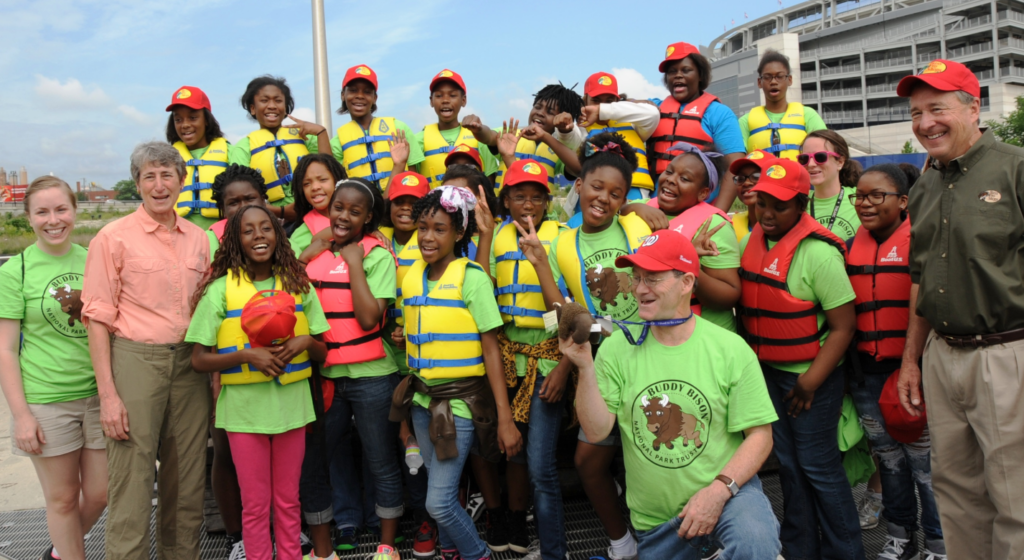 Johnny Morris posing with a group of youth during a fishing event in Washington, D.C.